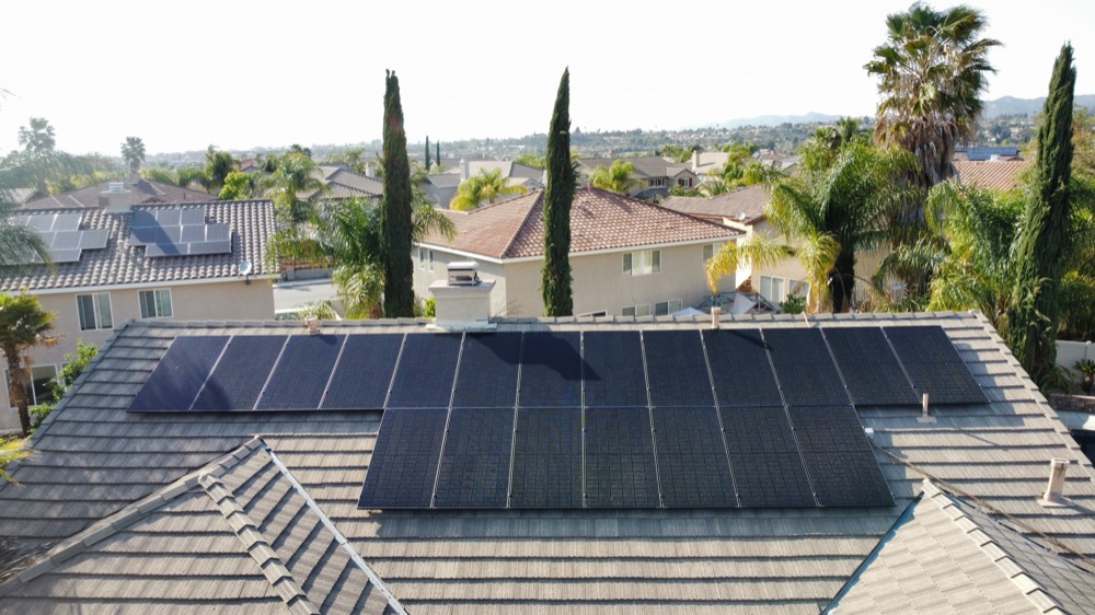 Tile roof solar install with palm trees